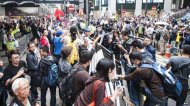 Pro-government protesters (left) shout to pro-democracy demonstrators (right) during the rally outside the Liaison Government Office in Hong Kong (9 November 2014)