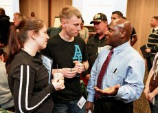 Spc. David Roberts, a movement control specialist with the 1177th Movement Control Team, and his wife, Alicia Roberts, chat with Master Sgt. Johnnie Davis, the senior command career counselor for the 7th Civil Support Command, during a Yellow Ribbon event sponsored by the 7th CSC, April 27 to 29.