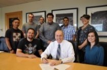 UCR students and veterans join Chancellor Kim Wilcox as he signs the Yellow Ribbon agreement.